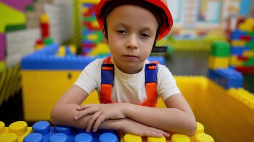 Young Child Dressed as Construction Worker with Toys