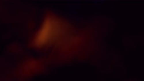 Golden Light Leaks and Flares Over Dark Background