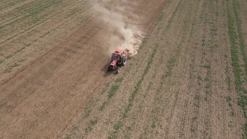 Small Tractor Cultivating Soil at Agricultural Field Aerial View