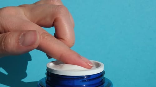 Finger Scooping Cream From a Container