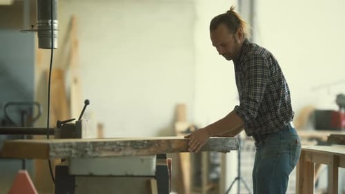 Carpenter Using Jointer Machine for Woodworking