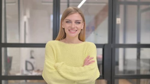 Smiling Woman With Arms Crossed in Office