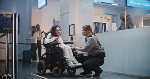 Airport Terminal Female Security Officer Inspecting Woman in Wheelchair for Boarding Plane Flight