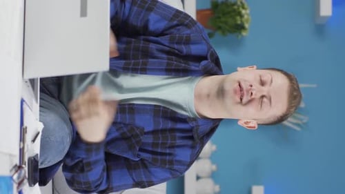 Vertical video of Home office worker man talking motivationally to camera.