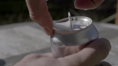 Close up of Hands Opening an Aluminum Can