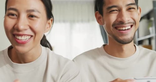 Happy Couple Playing Video Games Together at Home