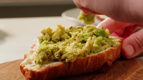 Preparing Cream Cheese and Avocado Toast at Home