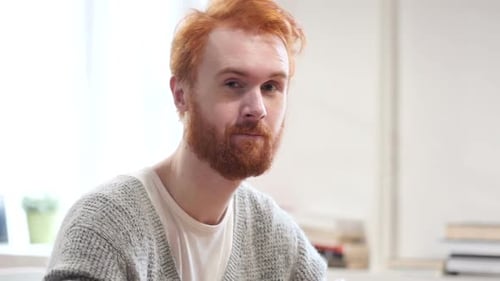 Red Haired Man Points and Makes Call Gesture