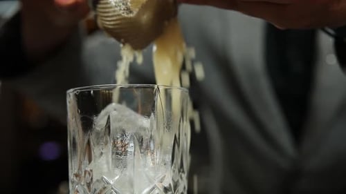 the bartender prepares a cocktail at the bar