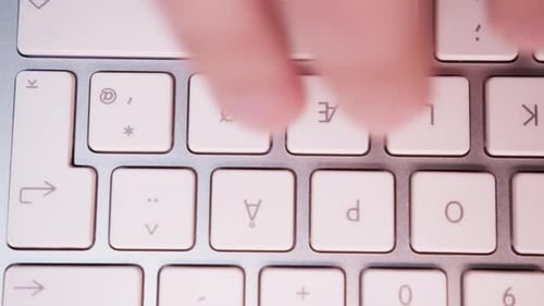 Close-up of Fingers Typing Something on White Keyboard