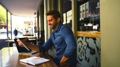 Tablet, notebook and remote work with a man in a coffee shop for business while typing an email