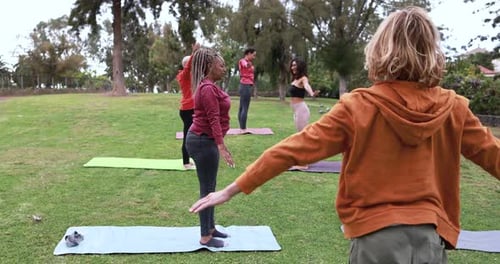 Yoga class at city park for sport and healthy lifestyle in the USA