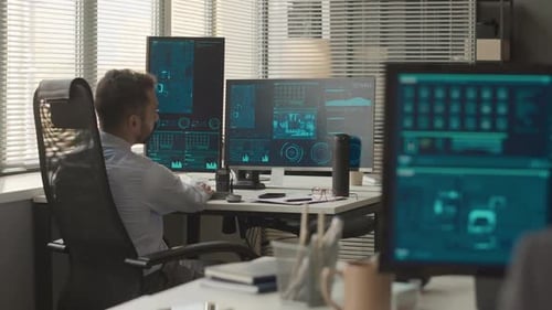 Cybersecurity Officers Working on Computers in Office