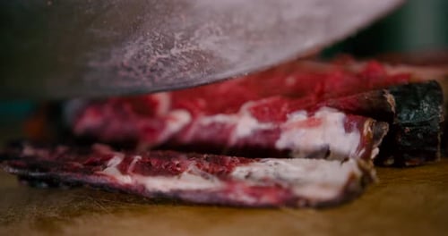 Close up view of Chef slicing the steak with Steel knife. Prepare meat before cooking, steak, bbq, m