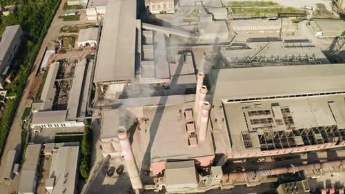 Smoke Plumes Billowing From Industrial Chimneys