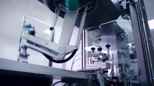 Automated robotic arm moves medicine blister packs