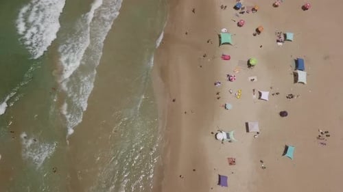 Summertime in a public Beach with colorful umbrellas