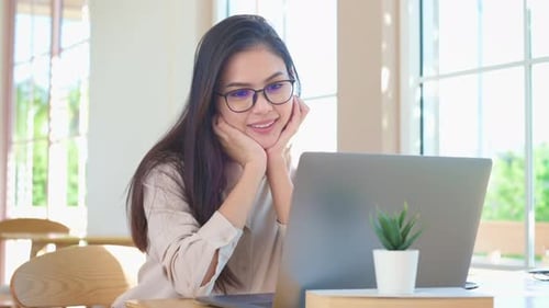 Young business woman working with her laptop in coffee shop