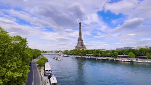 Aerial Drone Distant Sunset View of Tour Eiffel Tower and Seine River Bridge Traffic Cars Driving
