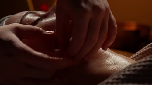 Closeup Relaxing Facial Massage with Soothing Oil Gentle Hands and Warm Ambient Light Emphasizing