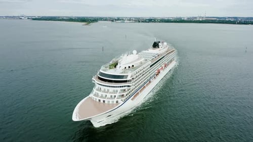 Aerial View of a Luxury Cruise Ship Sailing From the Port at Sunset