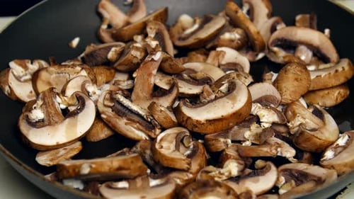 Time lapse of mushrooms cooking on the stove.