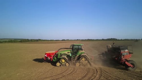 Tractor on the field seeding wheat