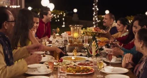Friends and Family Share Food at Nighttime Celebration