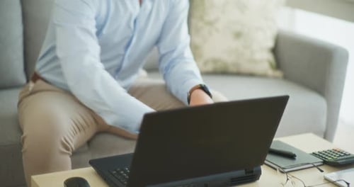 Modern Businessman Opens Laptop and Starts Working Remotely