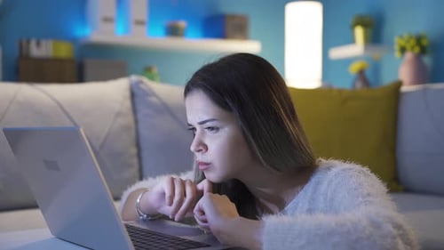 Woman Working on Laptop Computer at Night