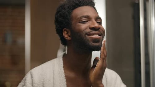 Man Applies Shaving Cream in Bathroom Mirror