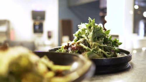 Close Up Gourmet Salads On The Pass In Restaurant