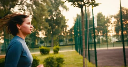 Young Sporty Woman Runner is Training in Morning in Public Park Fitness Girl is Jogging Outdoor