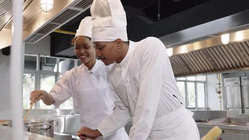 Afrikanische Köche bereiten gemeinsam Essen in einer kommerziell Großküche zu.