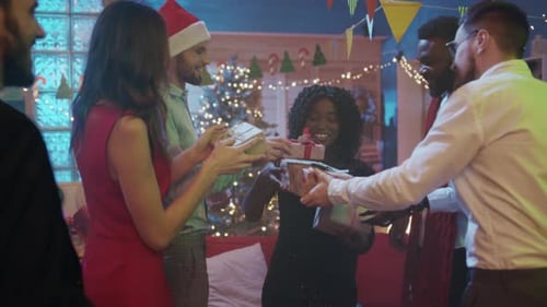 Friends Giving Christmas Gifts at Holiday Celebration