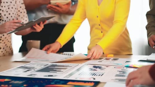 Team Brainstorming Meeting Analyzing Charts and Graph Data