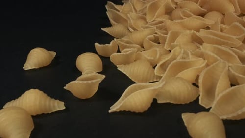 Close Up of Uncooked Pasta on Black Background with Copy Space
