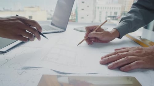 Collaborative Architects Reviewing Plans in Urban Office