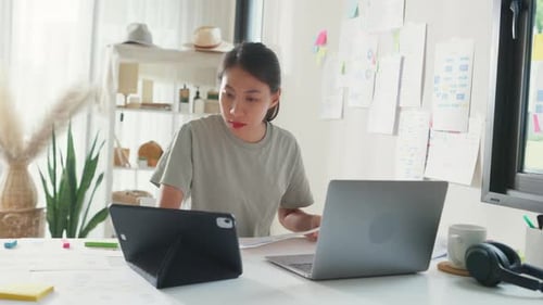 Asia girl IT development programmer typing on keyboard coding programming fixing data code on laptop