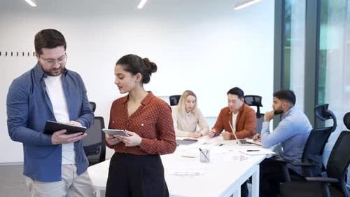 Business Meeting in Modern Office with Tablets