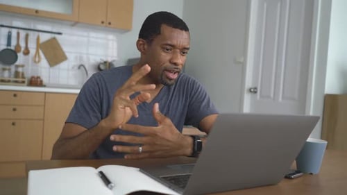 Man On Video Call At Kitchen Table