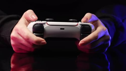 Hands Play Video Game with Controller in the Dark