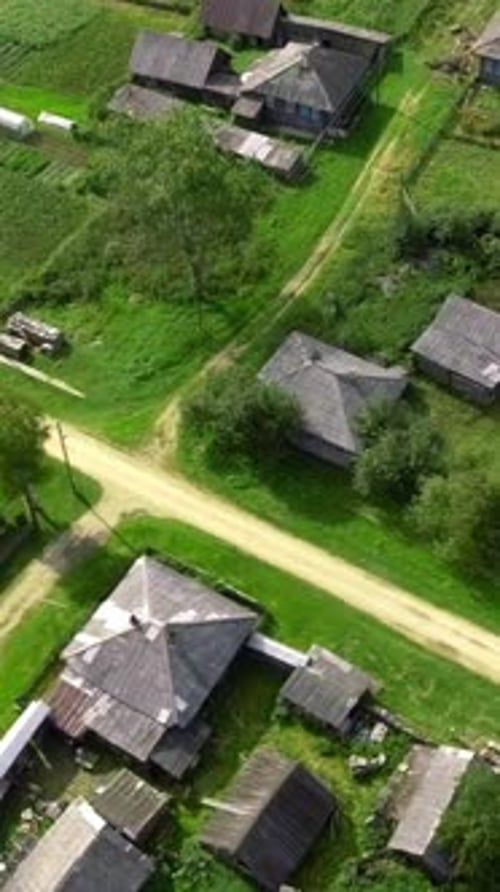 Top View of Rustic Cottages with Green Fields Stock Footage Neat Plots of Village Houses with Green
