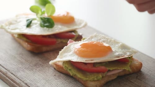 Preparing Toasts with Avocado, Tomato and Egg