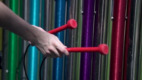 Close-Up of white Man Playing Percussion Instrument Outdoors in Park Musical Garden