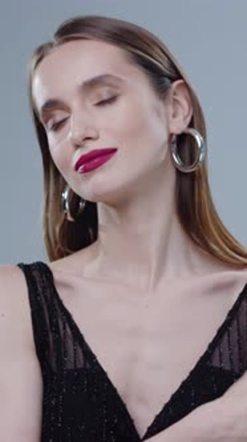 Elegant Woman Posing with Perfume Bottle