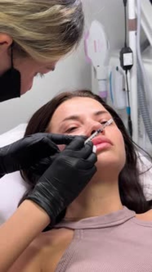 Woman Receives Lip Injections in a Medical Office