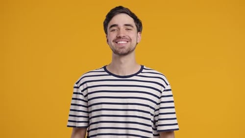 Young Friendly Man Smiling Confident Happy Guy In Striped Tshirt On Yellow