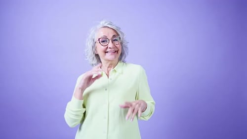 Senior Woman Dancing with Joy in Studio