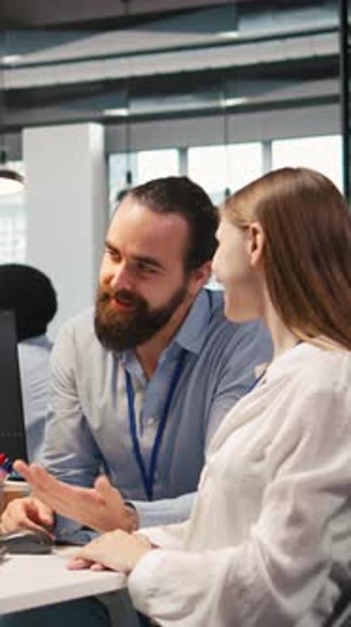Coworkers Collaborating at Computer in Office